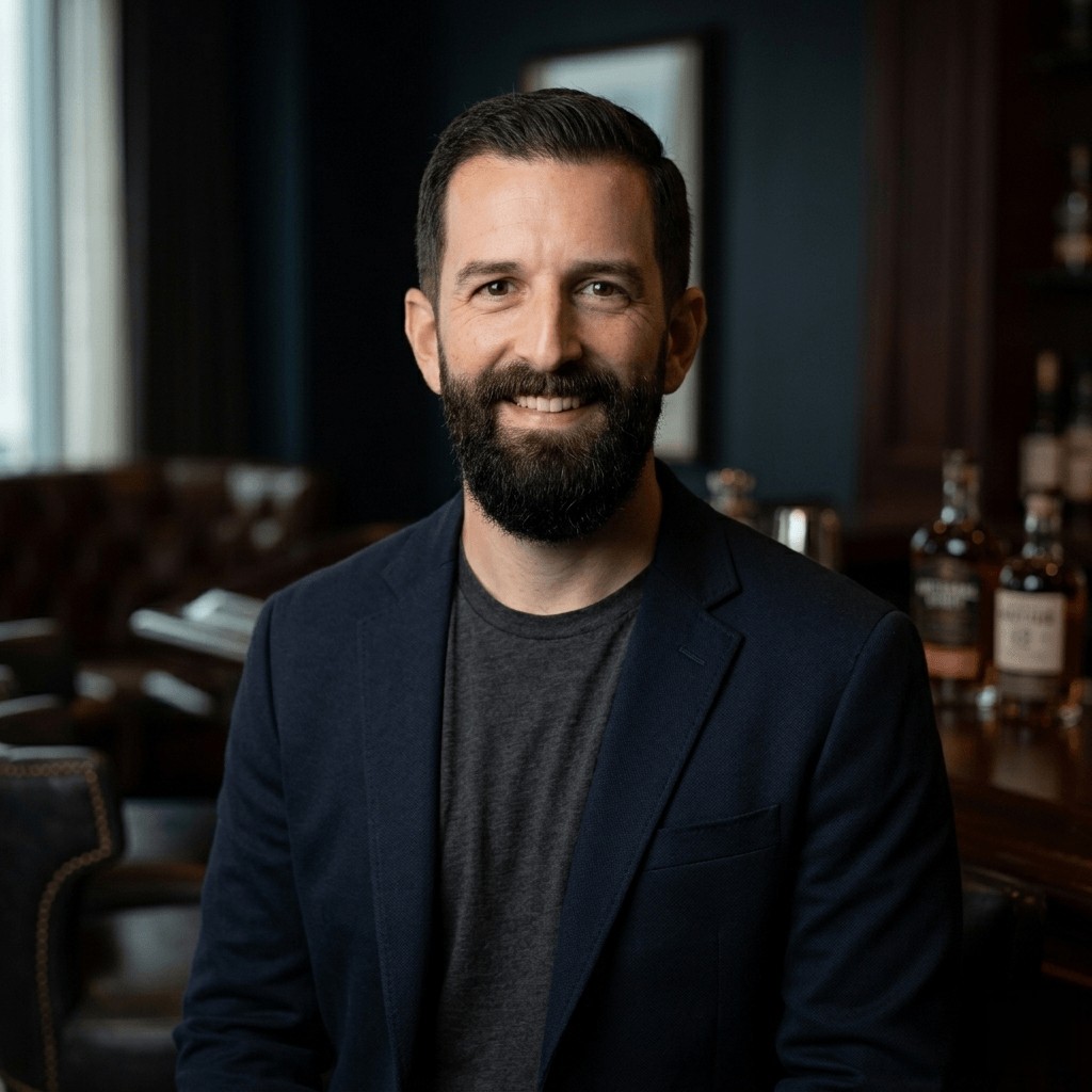 Jeremy Tyson, smiling, in a navy blazer and gray t-shirt